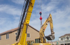 Cat Excavator over Fence