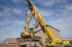 Cat Excavator over Fence