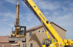 Cat Excavator over Fence