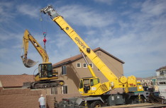 Cat Excavator over Fence