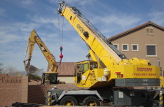 Cat Excavator over Fence