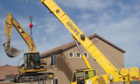 Cat Excavator over Fence